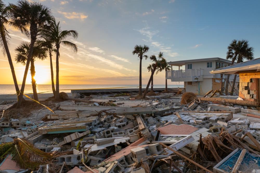 A house on the beach that has been pummeled by a hurricane.