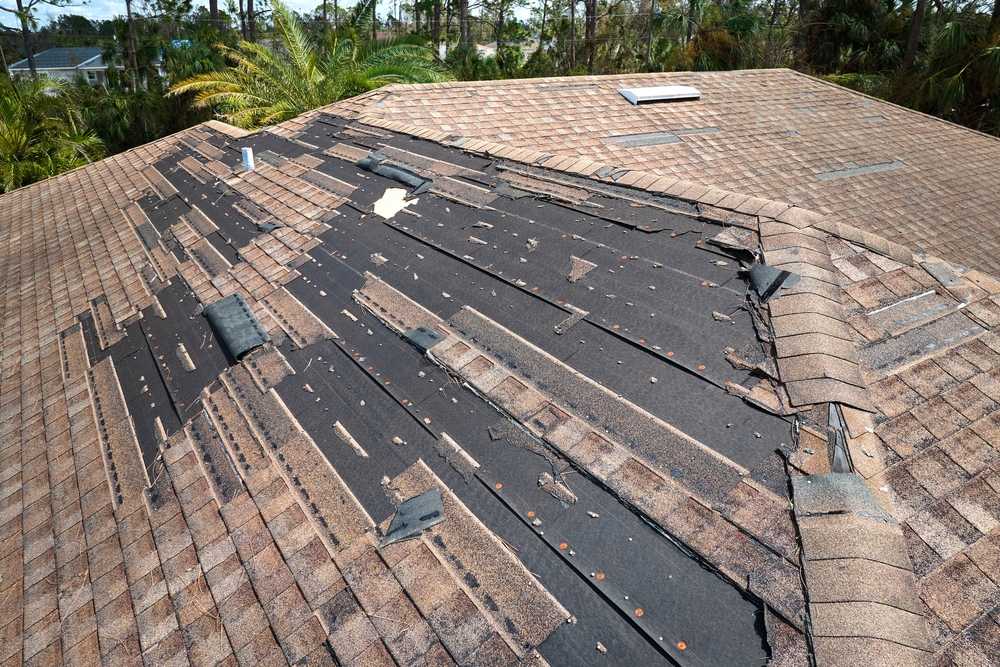 A roof missing many shingles.